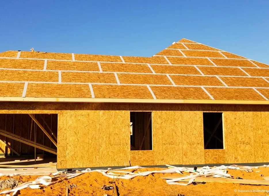 A new home under construction at the roof deck and framing stage