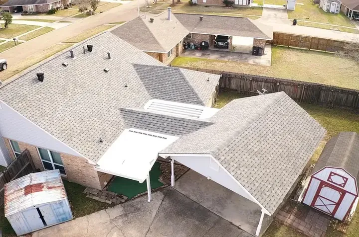 Aerial view of a large estate-style home with a pool and a complete new roof