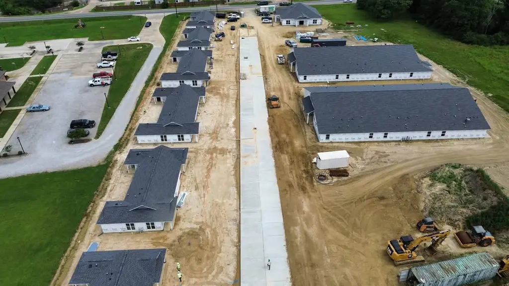 Aerial view of a row of new-construction homes with completed roofs