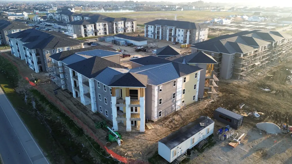 Aerial view of a multifamily roofing project underway in Ascension Parish
